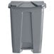A Lavex gray plastic rectangular step-on trash can with a lid.