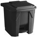 A black plastic Lavex step-on trash can with lid and handle.