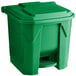 A green plastic Lavex step-on trash can with a lid.