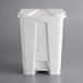 A white rectangular Lavex step-on trash can with a lid.