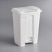 A white rectangular Lavex step-on trash can with a lid.
