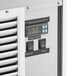 The digital temperature control panel for an Avantco white horizontal air curtain merchandiser.