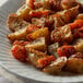 A plate of food with roasted potatoes and carrots seasoned with Regal rosemary leaves.