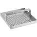 A metal square floor drain strainer with a handle and a metal grid with holes.