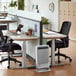 A white desk with two black office chairs and a AeraMax Pro II Wall-Mount Air Purifier above it.