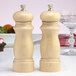 A Chef Specialties Salem natural finish wooden salt and pepper mill set on a table.