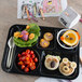 A Carlisle black 6 compartment tray with food on it.