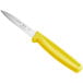 A Choice serrated paring knife with a yellow handle.