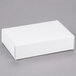 A white rectangular 1-piece candy box on a gray surface.