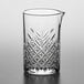 A Pasabahce Timeless Vintage stirring glass with a design on it.