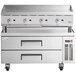 A stainless steel countertop with a Cooking Performance Group gas griddle and refrigerated chef base.