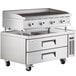 A large stainless steel countertop with a Cooking Performance Group radiant charbroiler and refrigerated chef base.