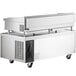 A large stainless steel Cooking Performance Group gas countertop griddle with manual controls over 2 refrigerated drawers.