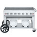 A Crown Verity mobile outdoor grill with two white propane tanks on a cart.