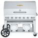 A Crown Verity stainless steel outdoor grill with roll dome package on a cart with two white propane tanks.