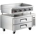 A Cooking Performance Group stainless steel countertop with a 48" griddle and 2 refrigerated drawers.