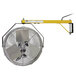 A yellow and white TPI Fostoria wall-mount industrial fan with a metal hook.