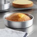 A round cake in a Choice silver aluminum cake pan.