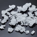 A pile of white flake ice on a surface.