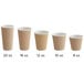 A row of Choice brown paper hot cups with a white rim.