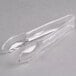 A pair of clear plastic tongs with scalloped edges.