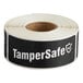 A roll of black TamperSafe labels with white text.