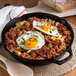 A skillet of food with eggs and meat including 6 lb. imported canned corned beef.