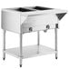 A ServIt stainless steel natural gas steam table with two pans on an undershelf.