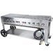 A Crown Verity MCB-72 natural gas stainless steel grill on a counter with wheels.