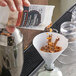 A person pouring Rokz Cinnamon Spice infusion into a glass.