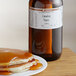 A plate of pancakes with Canadian Maple syrup next to a bottle of LorAnn Oils Canadian Maple Super Strength Flavor.