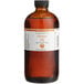 A bottle of LorAnn Oils All-Natural Orange Super Strength Flavor on a counter.