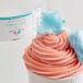 A cup of pink and blue cotton candy with pink and blue swirls.