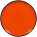 A RAK Porcelain orange rimless plate with a black rim.