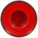 A red RAK Porcelain saucer with a black rim.