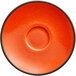 An orange porcelain saucer with a black rim.