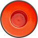 An orange RAK Porcelain saucer with a rim.