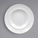 A close-up of a RAK Porcelain Soul white porcelain plate with a textured wide rim.