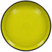 A yellow porcelain plate with a black rim.