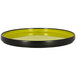 A green rimless porcelain plate with a yellow and black surface.