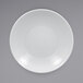 A close-up of a RAK Porcelain bright white deep coupe plate with an embossed rim.
