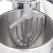A Hobart mixer with a Hobart aluminum flat beater attachment on a metal bowl.