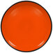 An orange RAK Porcelain deep plate with black rim.