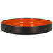 A black and orange RAK Porcelain deep plate with a black rim on a white surface.