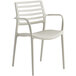 A beige plastic arm chair by Lancaster Table & Seating.