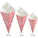 A white and red Carnival King box with three red and white square cardboard fry cones inside.