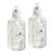 Two clear plastic bottles of Sloan foam soap with pumps.