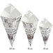 A group of Carnival King newspaper print cone-shaped cardboard containers.
