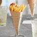 A Carnival King Kraft cardboard cone filled with French fries.