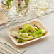 A TreeVive by EcoChoice compostable wooden rectangular plate with food on it.